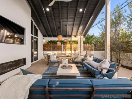 a view of a patio with table and chairs and floor to ceiling window