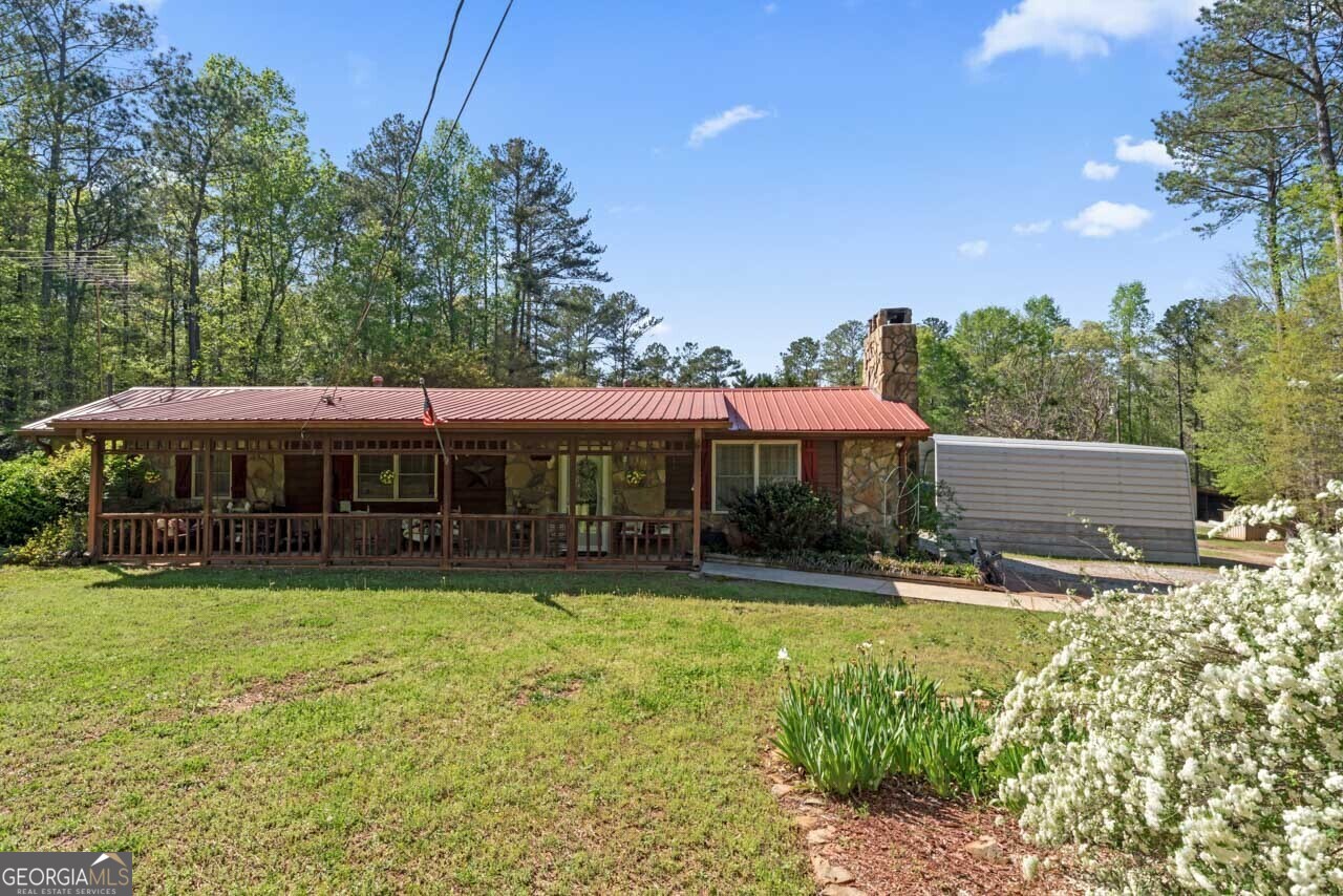 a view of a house with swimming pool and yard