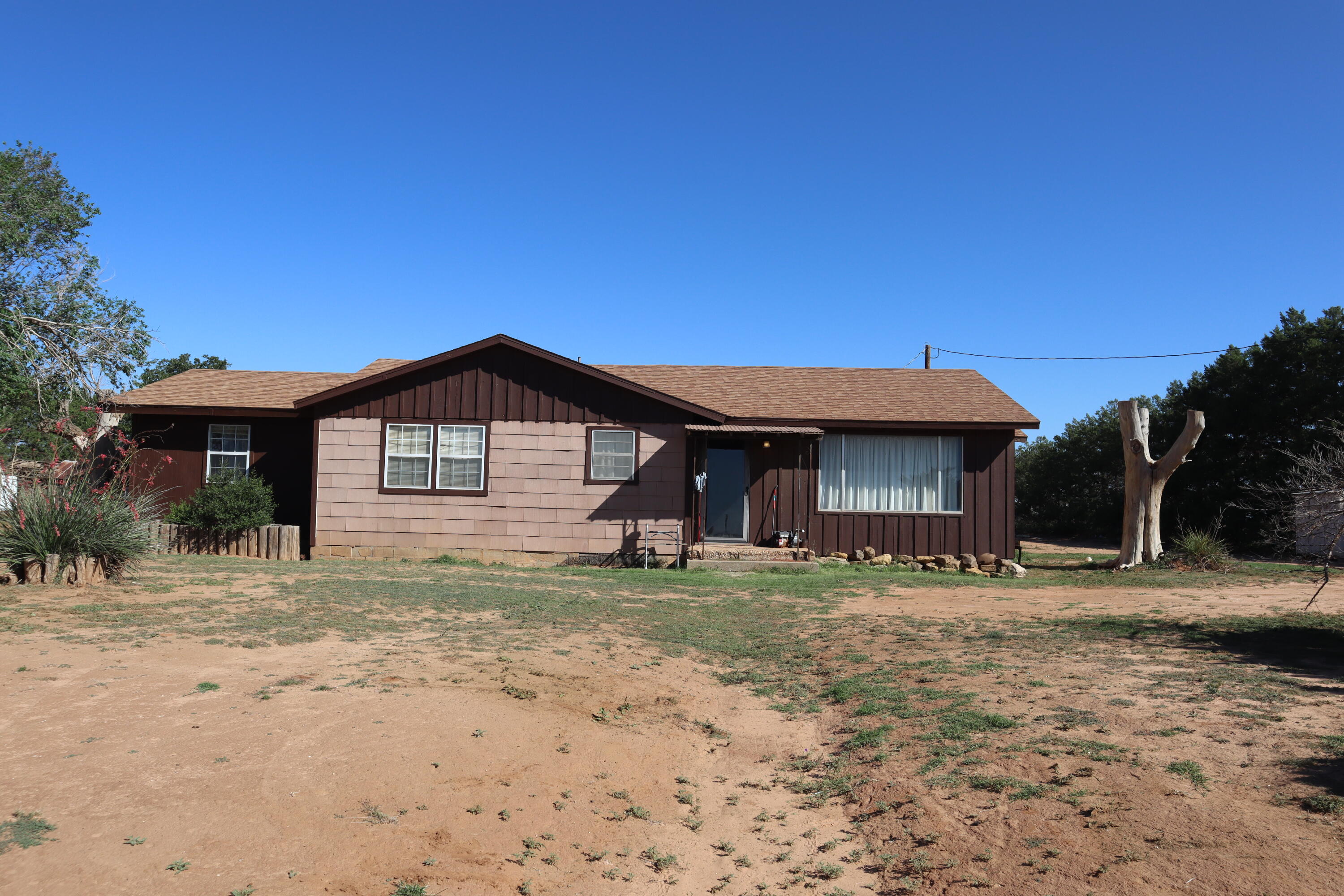 5993 Jaguar Road Levelland, TX 79336 - Photo 3 of 24 a house with trees in the background