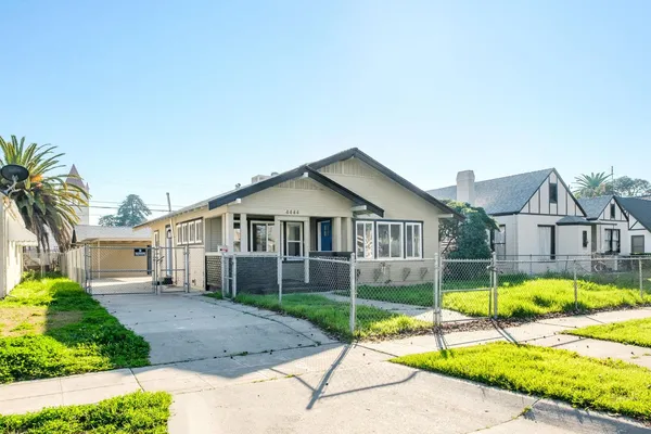 a view of a house with a swimming pool and a yard
