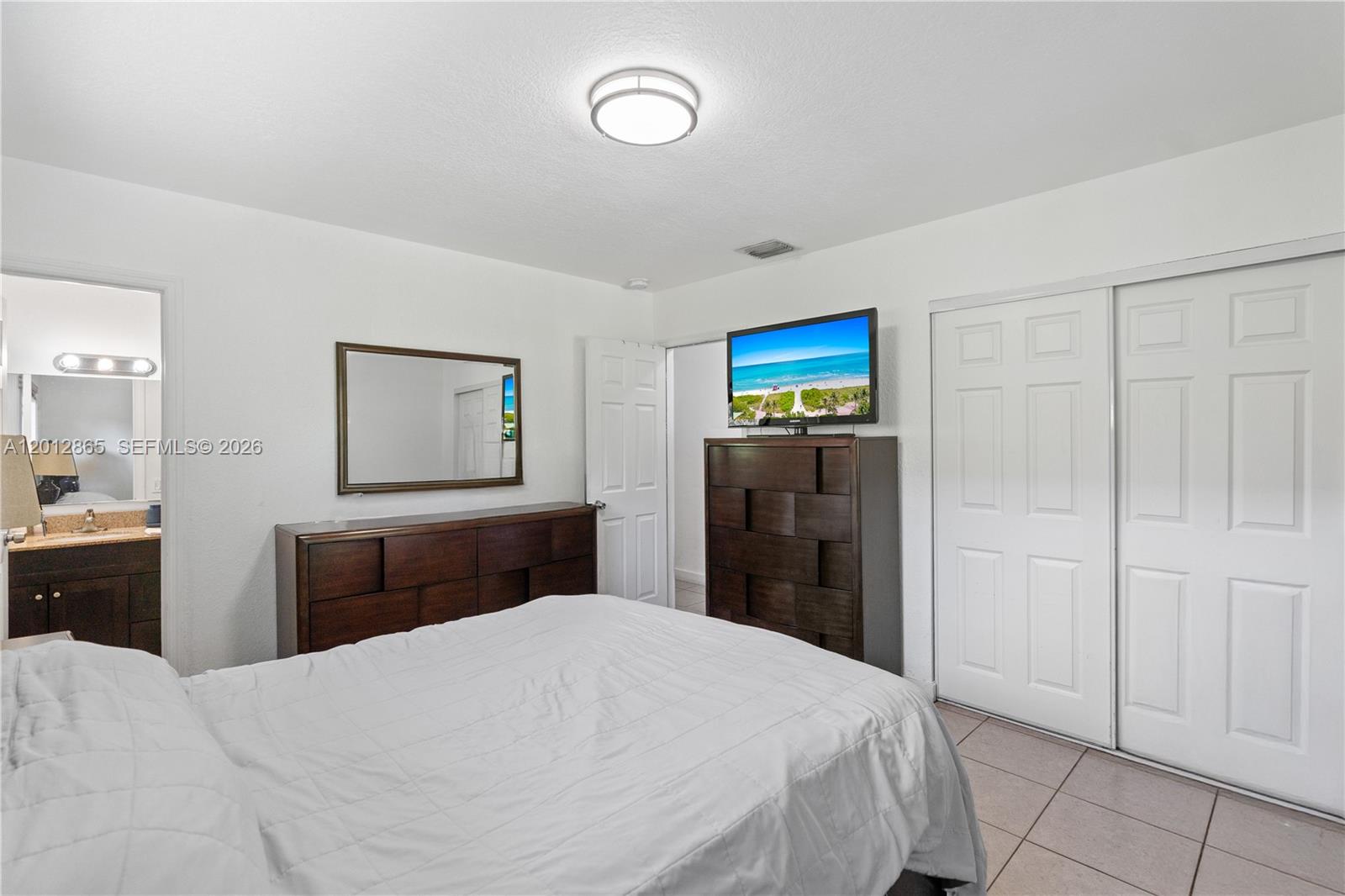 5300 Northwest 30th Place Miami, FL 33142 - Photo 15 of 35 a bedroom with a bed and a dresser