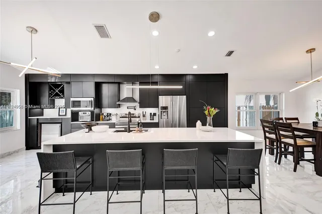 a large kitchen with a table and chairs