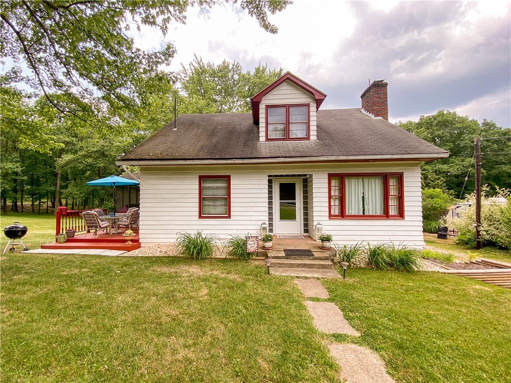 145 Stuber Road New Brighton, PA 15066 - Photo 1 of 27 a front view of a house with a yard table and chairs
