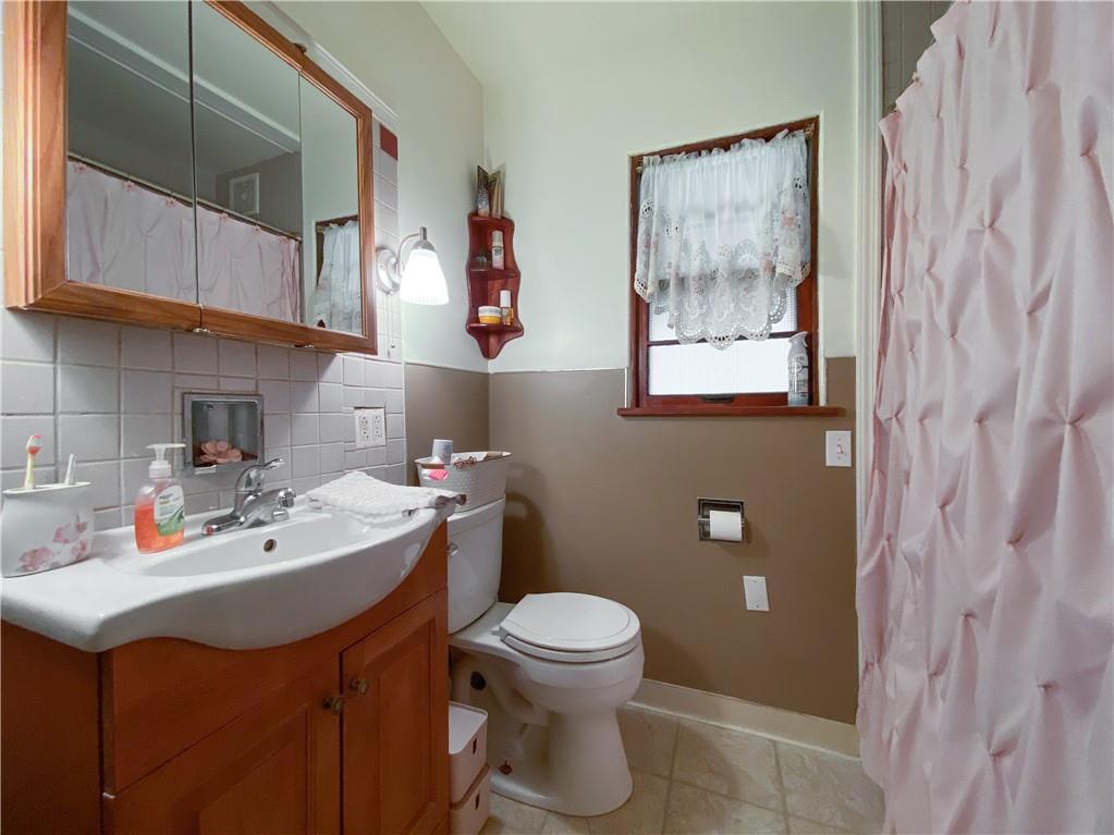 145 Stuber Road New Brighton, PA 15066 - Photo 16 of 27 a bathroom with a sink toilet and a mirror