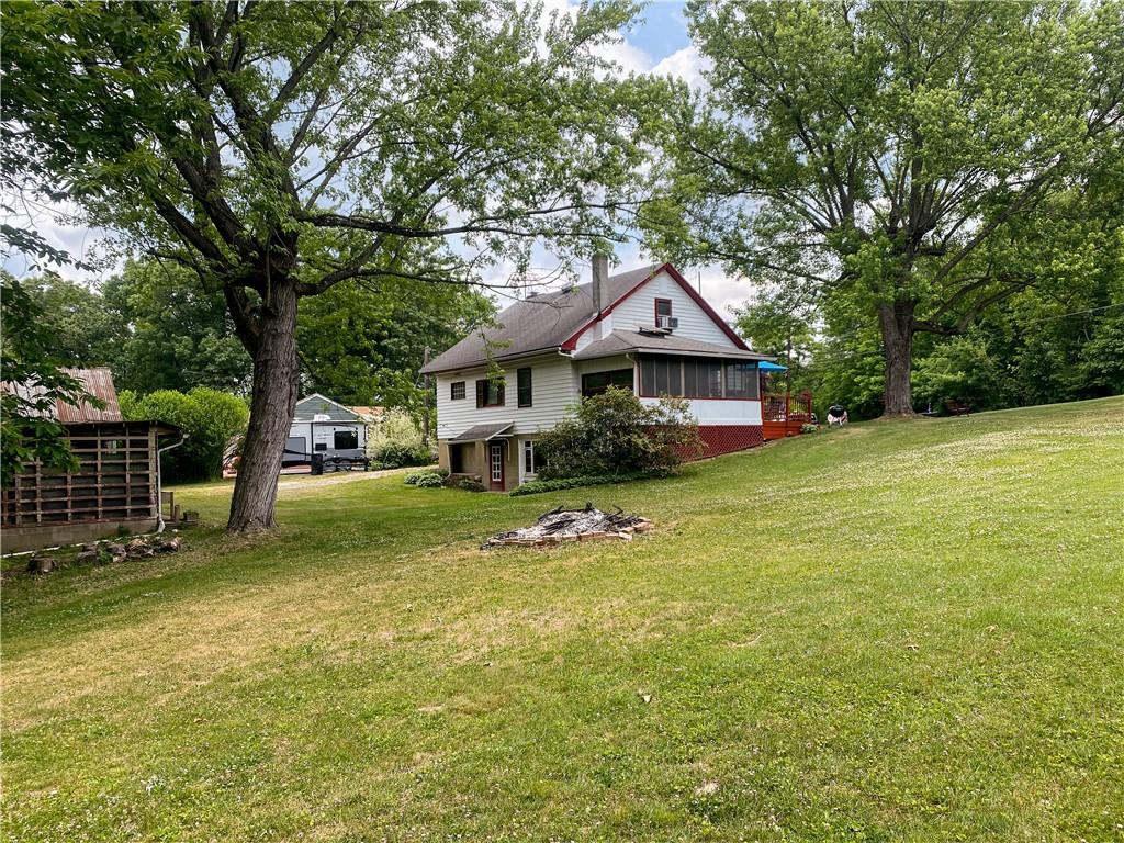 145 Stuber Road New Brighton, PA 15066 - Photo 7 of 27 a front view of a house with a garden and tree