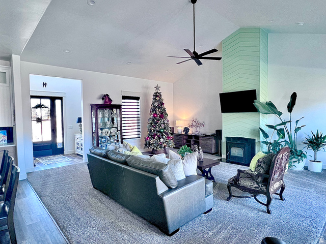 1952 Highway 118 Monroe, UT 84754 - Photo 17 of 88 Living area featuring high vaulted ceiling, a large fireplace, and a ceiling fan