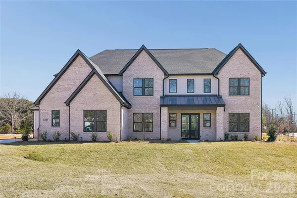 a kitchen with stainless steel appliances kitchen island granite countertop a sink a stove and a wooden floors