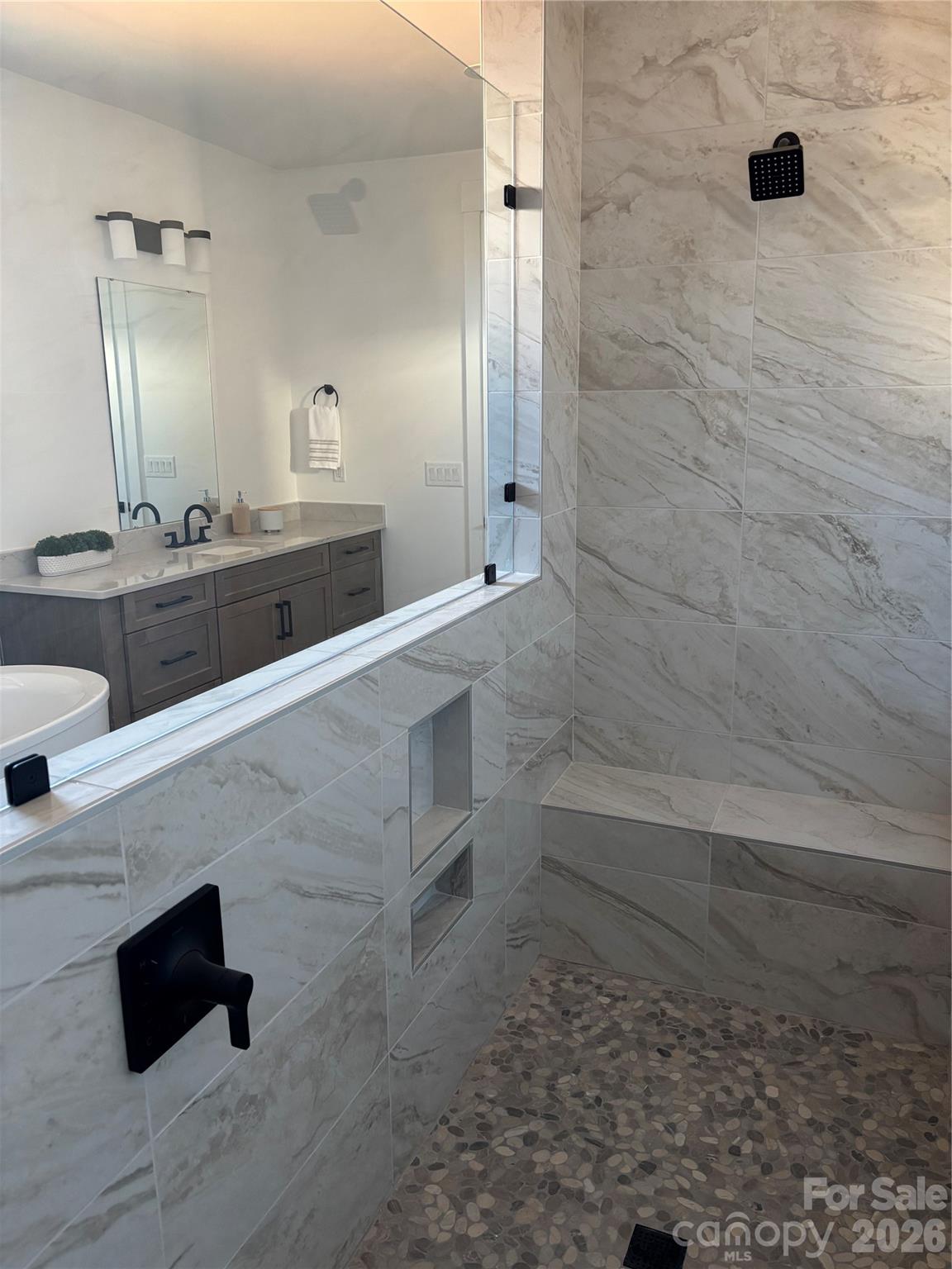 1027 Cox Road, Unit 12 Weddington, NC 28104 - Photo 20 of 32 a bathroom with a double vanity sink a toilet a mirror and shower