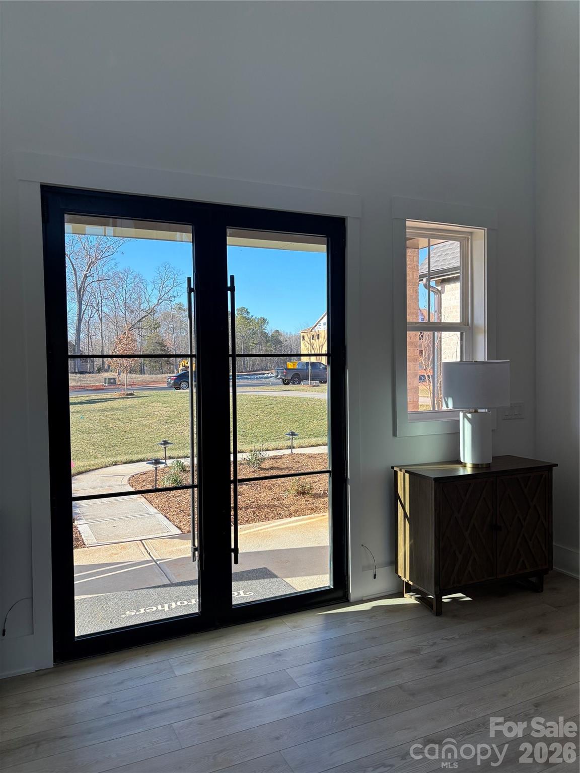 1027 Cox Road, Unit 12 Weddington, NC 28104 - Photo 2 of 32 an empty room with wooden floor and windows