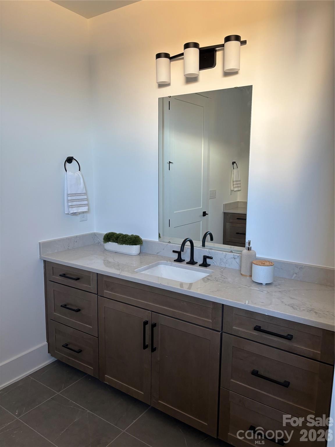 1027 Cox Road, Unit 12 Weddington, NC 28104 - Photo 21 of 32 a bathroom with a granite countertop sink and a mirror
