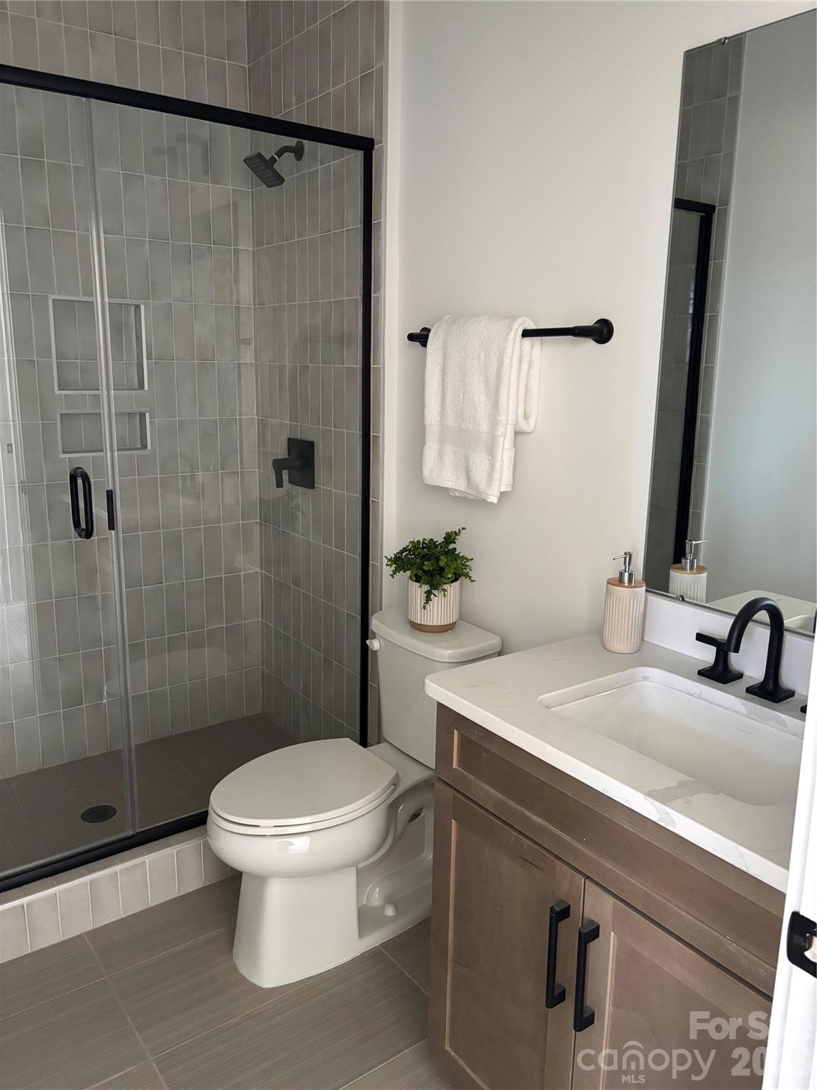 1027 Cox Road, Unit 12 Weddington, NC 28104 - Photo 24 of 32 a bathroom with a sink toilet and shower