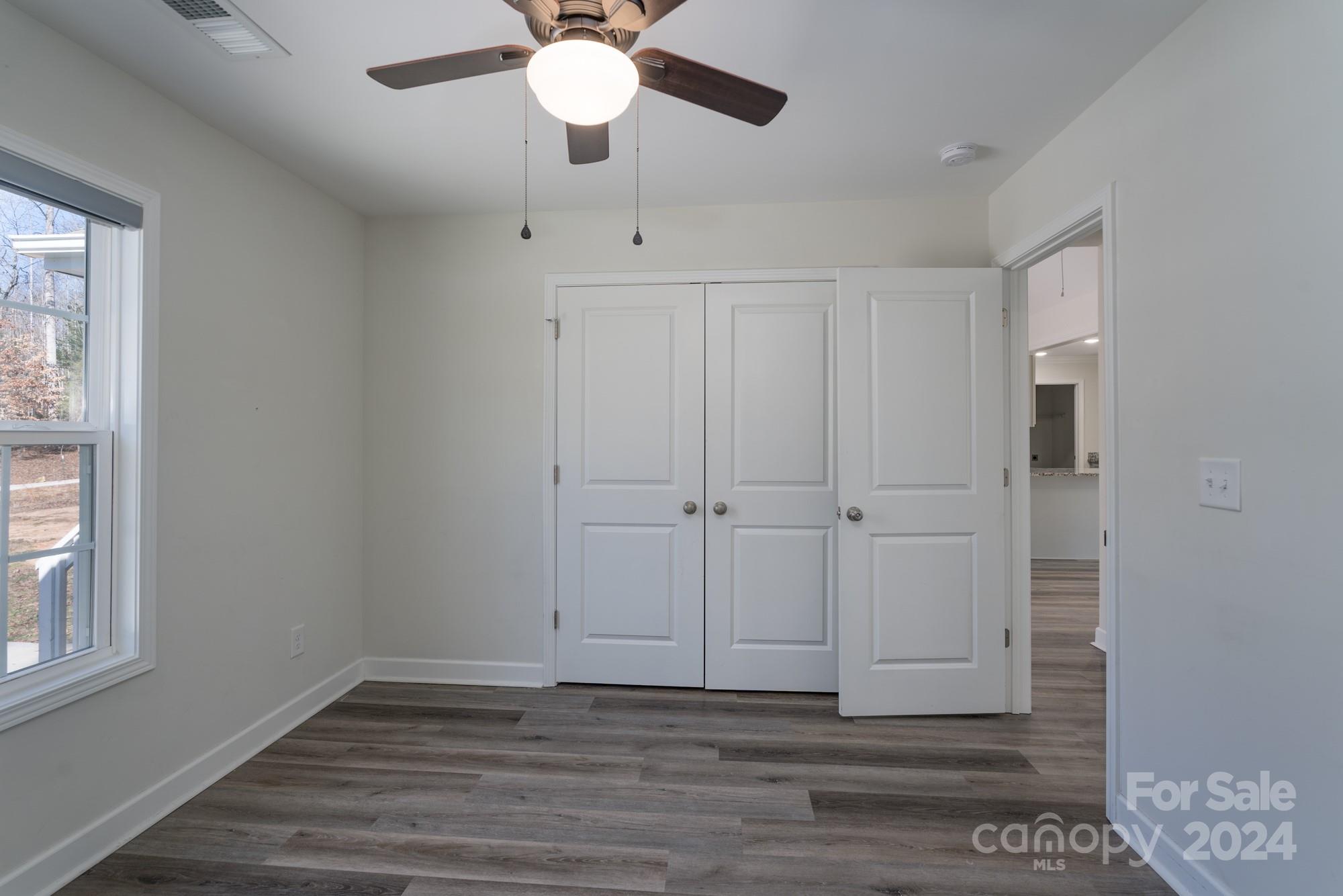 1121 Thompson Davis Road York, SC 29745 - Photo 17 of 28 a view of an empty room with wooden floor and a window