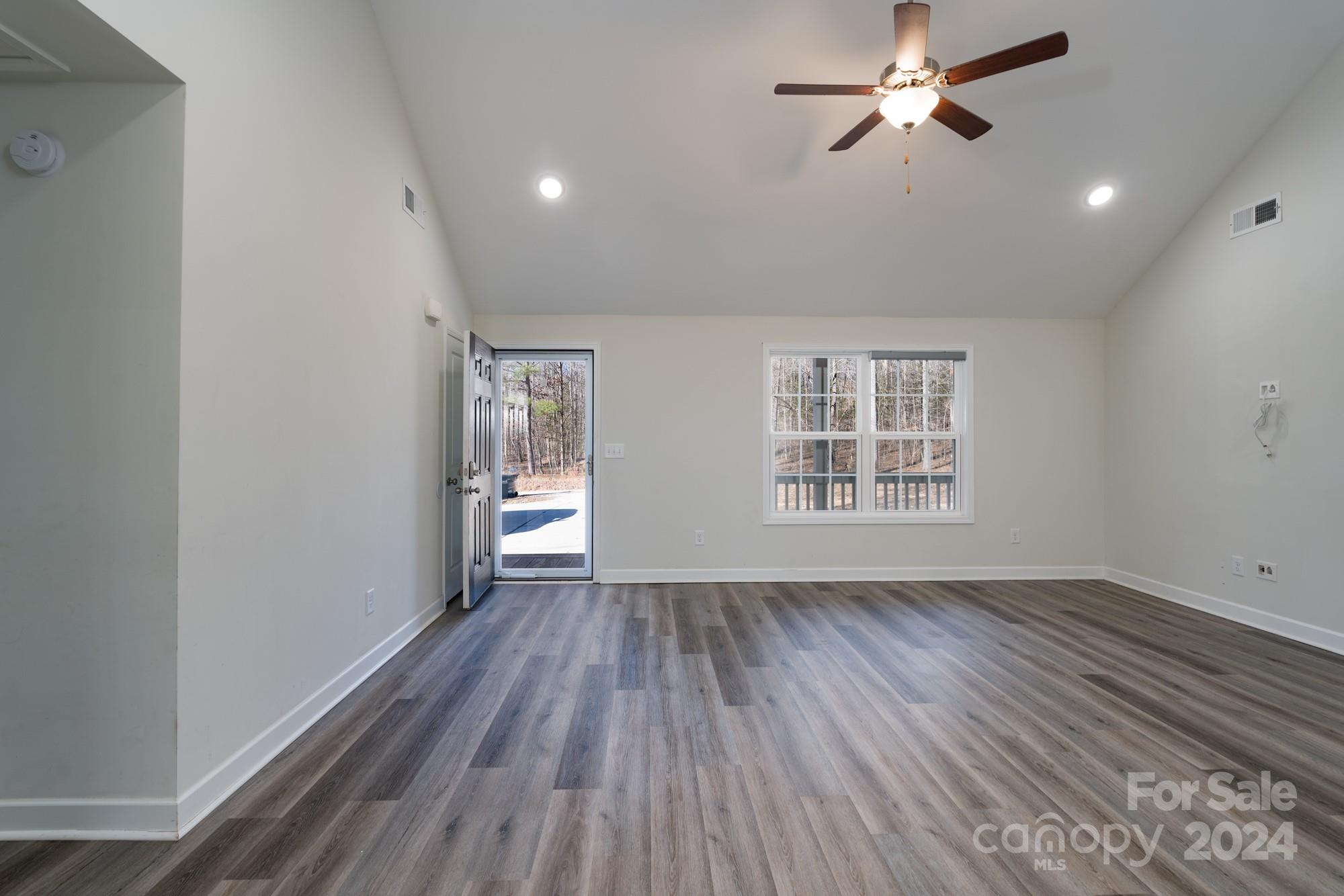1121 Thompson Davis Road York, SC 29745 - Photo 4 of 28 wooden floor in an empty room with a window