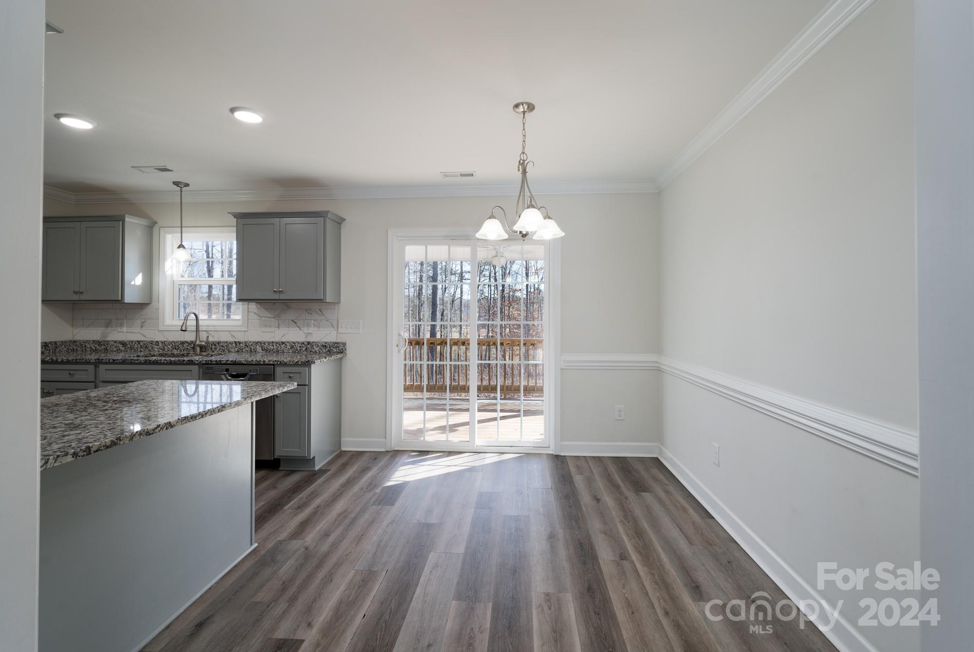 1121 Thompson Davis Road York, SC 29745 - Photo 7 of 28 a kitchen with granite countertop a stove and a wooden floors
