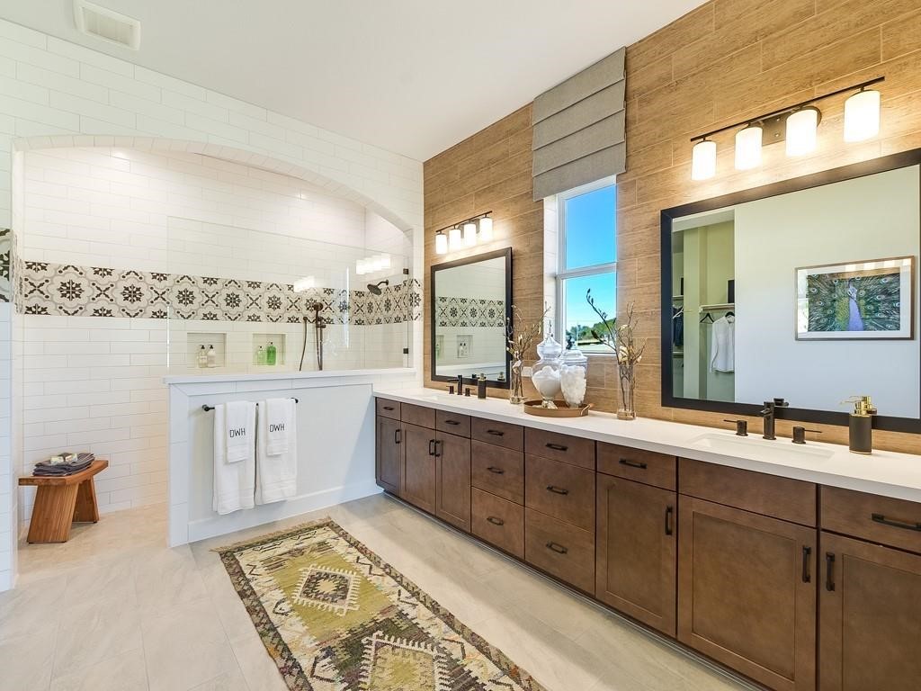175 Call Drive Austin, TX 78737 - Photo 13 of 28 a large bathroom with a double vanity sink a mirror and a bathtub