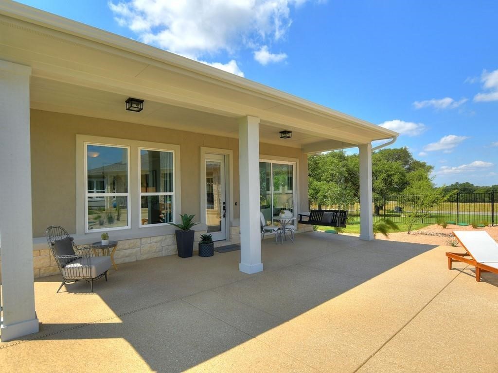 175 Call Drive Austin, TX 78737 - Photo 25 of 28 a view of a house with backyard sitting area and garden