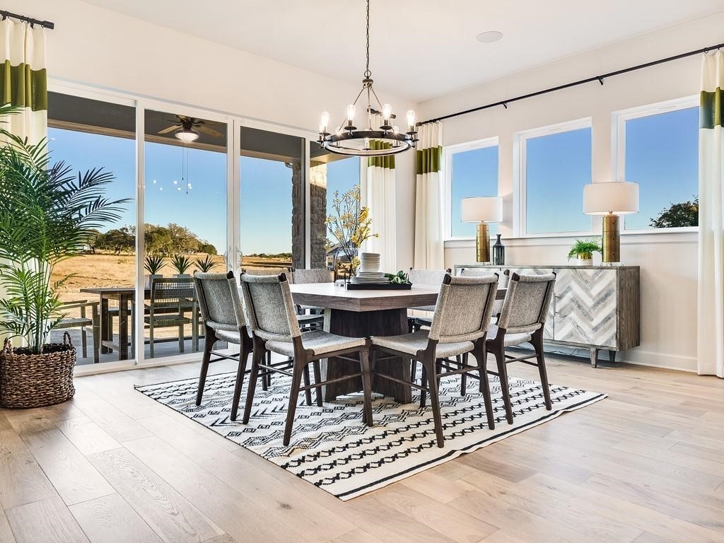 175 Call Drive Austin, TX 78737 - Photo 10 of 28 a view of a dining room with furniture window and wooden floor