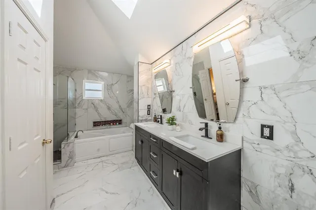 a bathroom with a bathtub and a shower