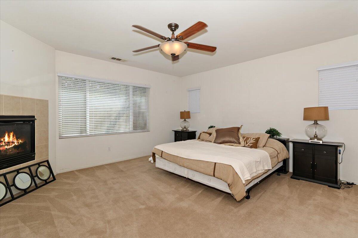49528 Pacino Street Indio, CA 92201 - Photo 16 of 22 a bedroom with a bed and window