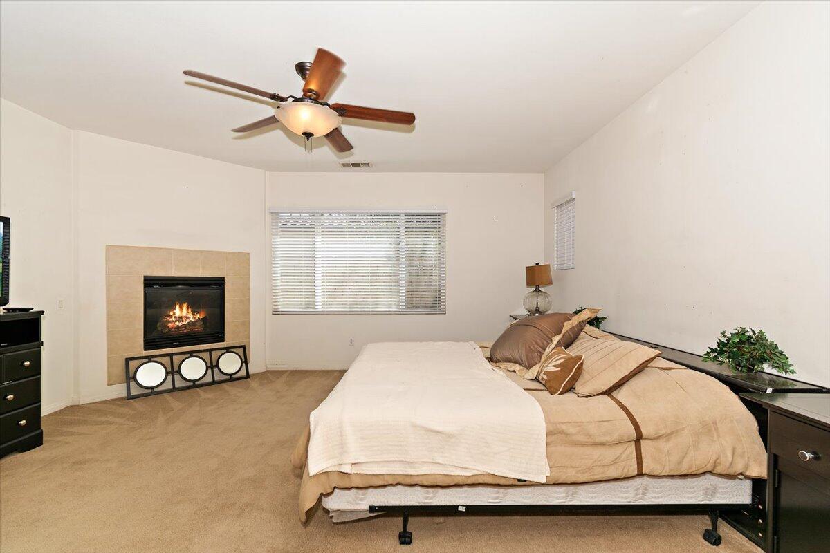 49528 Pacino Street Indio, CA 92201 - Photo 21 of 22 a bedroom with a bed and ceiling fan