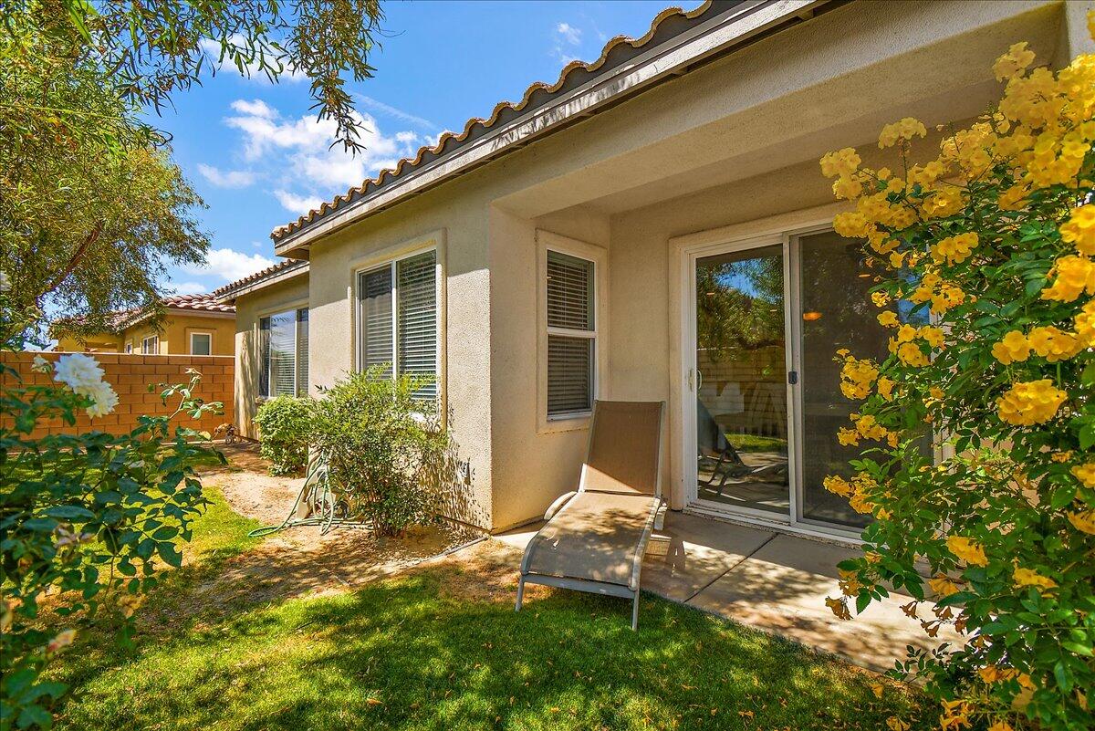 49528 Pacino Street Indio, CA 92201 - Photo 22 of 22 a backyard of a house with outdoor seating and plants