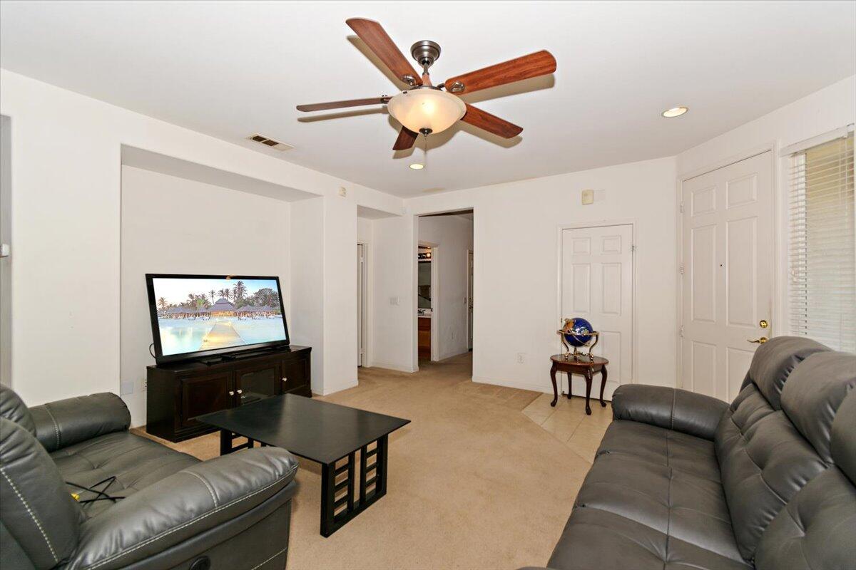 49528 Pacino Street Indio, CA 92201 - Photo 4 of 22 a living room with furniture and a large window
