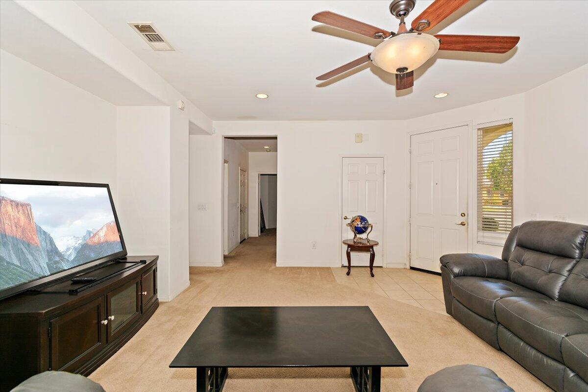 49528 Pacino Street Indio, CA 92201 - Photo 5 of 22 a living room with furniture and a flat screen tv