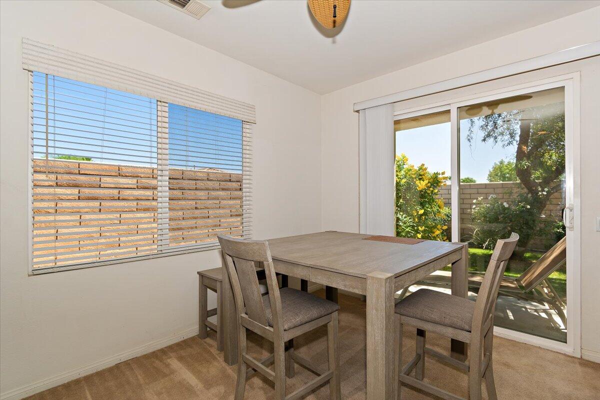 49528 Pacino Street Indio, CA 92201 - Photo 7 of 22 a view of a dining room with furniture and a window