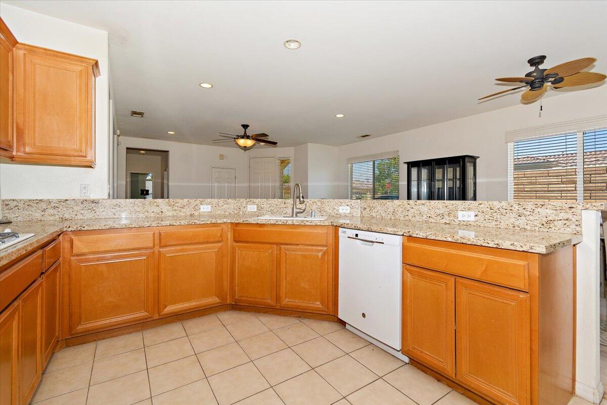49528 Pacino Street Indio, CA 92201 - Photo 9 of 22 a kitchen with granite countertop a sink and cabinets