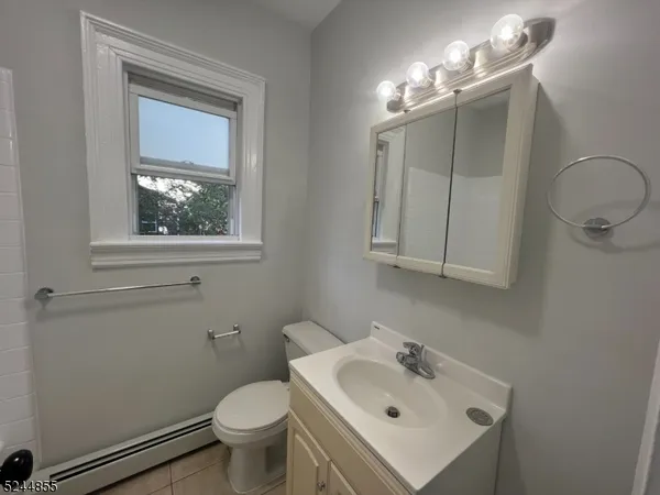 a bathroom with a sink toilet and mirror