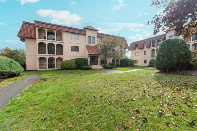 a view of a building with a yard