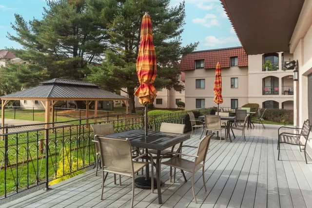 a view of a patio with table and chairs and wooden floor