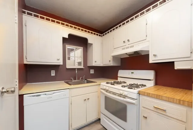 a view of kitchen with a sink and a stove top oven