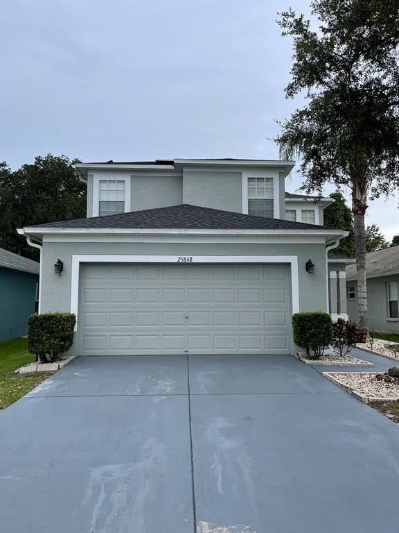 a front view of a house with garage