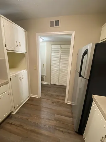a view of hallway with wooden floor