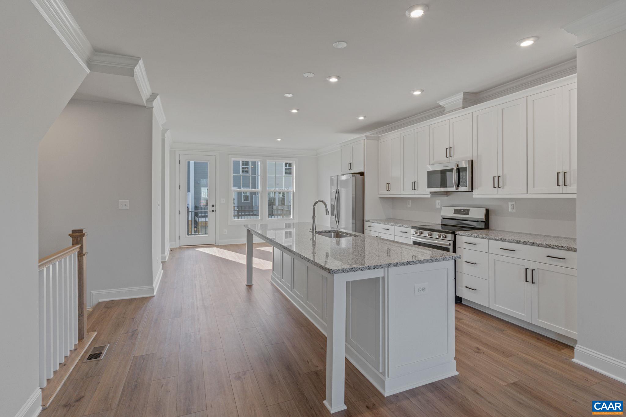 2247 Woodburn Road Charlottesville, VA 22901 - Photo 1 of 9 a kitchen with stainless steel appliances granite countertop a stove top oven a sink a refrigerator and white cabinets with wooden floor