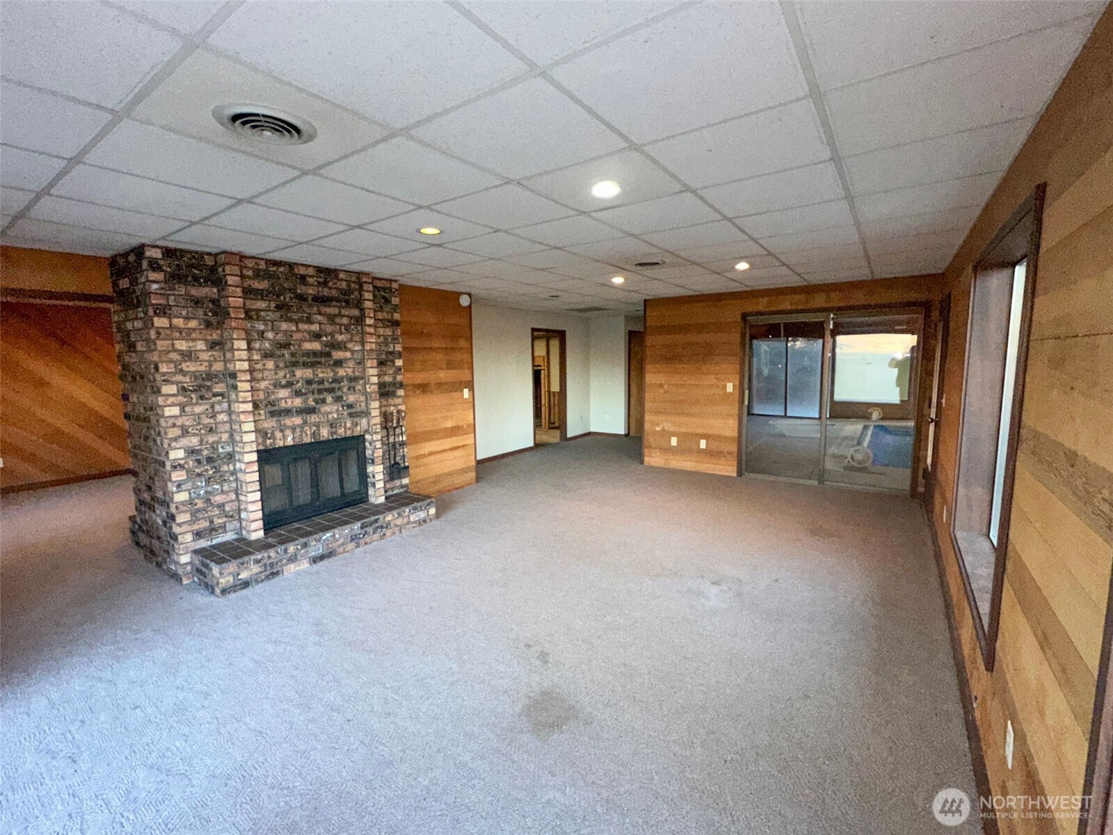 1303 Nightingale Road Wapato, WA 98951 - Photo 17 of 32 a view of an empty room with a fireplace and a window
