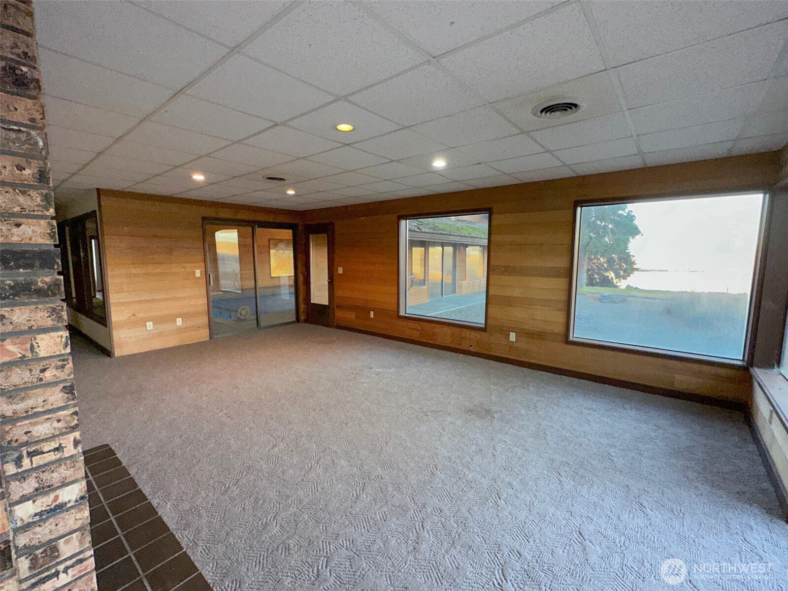 1303 Nightingale Road Wapato, WA 98951 - Photo 26 of 32 a view of an empty room with wooden floor and windows