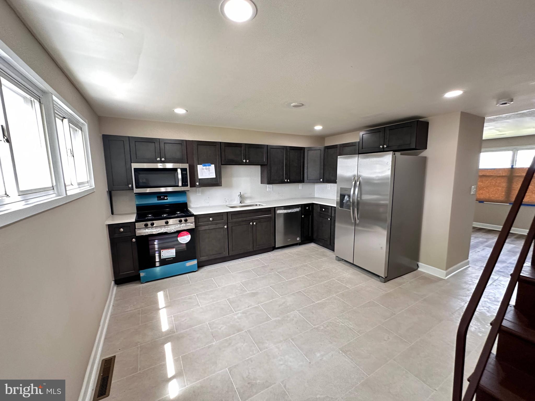 8039 Gough Street Baltimore, MD 21224 - Photo 1 of 17 a kitchen with stainless steel appliances a refrigerator and a sink