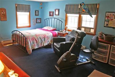 157 Poponessett Road Cotuit, MA 02635 - Photo 11 of 25 a bedroom with a bed and a window