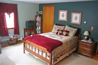 157 Poponessett Road Cotuit, MA 02635 - Photo 13 of 25 a bedroom with a bed and a tv in it