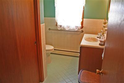 157 Poponessett Road Cotuit, MA 02635 - Photo 17 of 25 a bathroom with a sink and toilet