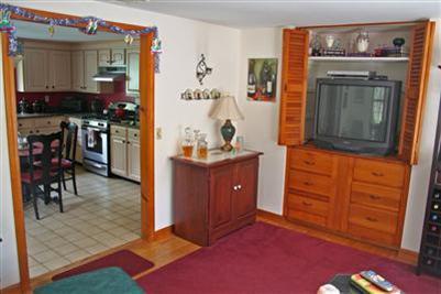 157 Poponessett Road Cotuit, MA 02635 - Photo 3 of 25 a view of kitchen with furniture and flat screen tv