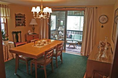 157 Poponessett Road Cotuit, MA 02635 - Photo 5 of 25 a view of a dining room with furniture a chandelier and large window