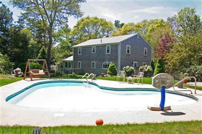 157 Poponessett Road Cotuit, MA 02635 - Photo 7 of 25 a view of a house with backyard swimming pool and sitting area