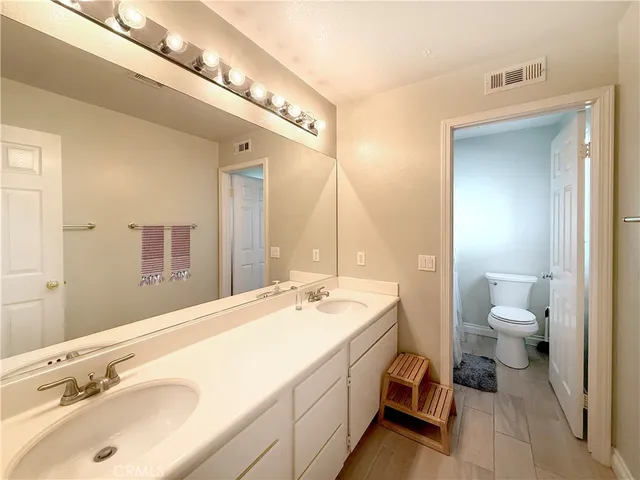 a spacious bathroom with a sink and a mirror