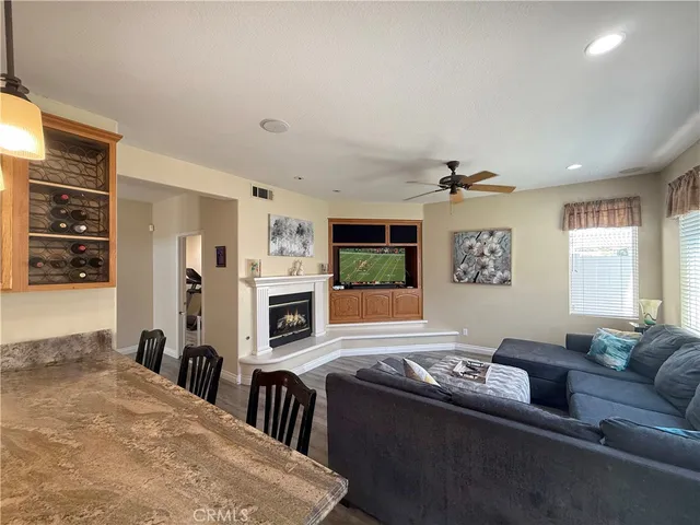 a living room with furniture flat screen tv and window