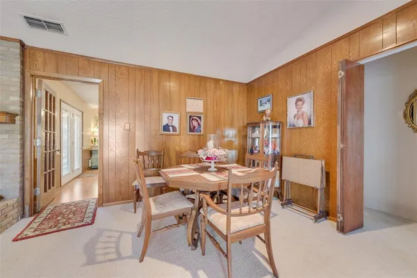 a view of a dining room with furniture and a chandelier