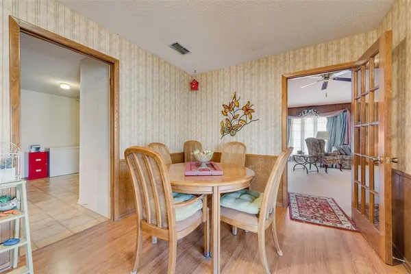 a view of a dining room with furniture and a potted plant