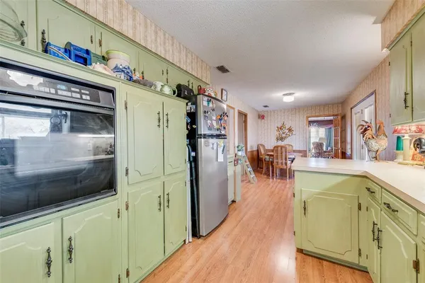 a view of a kitchen cabinets and a wooden floor